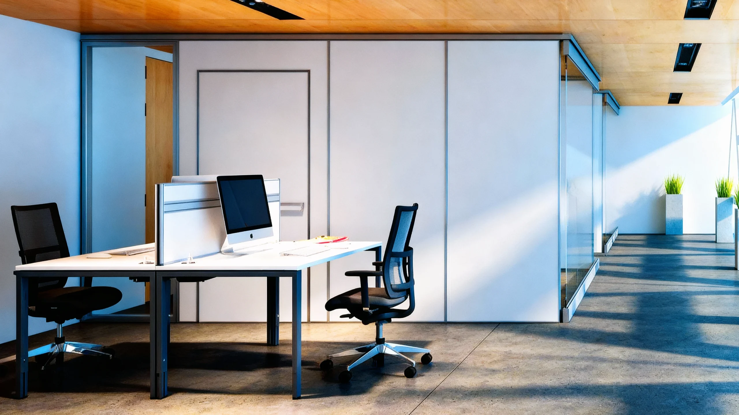 Komandor Aurora partition system creates a functional office buildout by dividing a large open space into private rooms and corridors. This architectural solution utilizes high-density 6063-T5 anodized aluminum frames to secure solid and glass panels directly to the room structure without requiring traditional drywall framing or additional bulkheads. The precision-engineered system allows for floor-to-ceiling customization to the nearest 1/32 inch, maintaining light transmission through integrated glazing while ensuring structural integrity and privacy in a modern commercial environment.